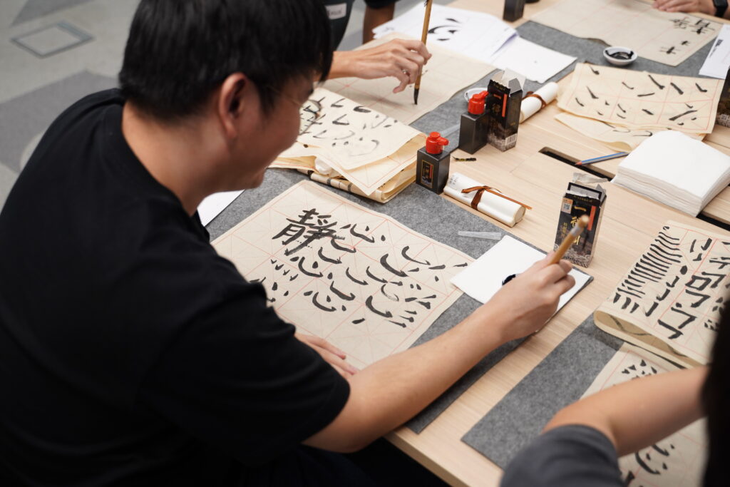 Some close ups of our SITizen practicing the strokes and dots of the Chinese characters.