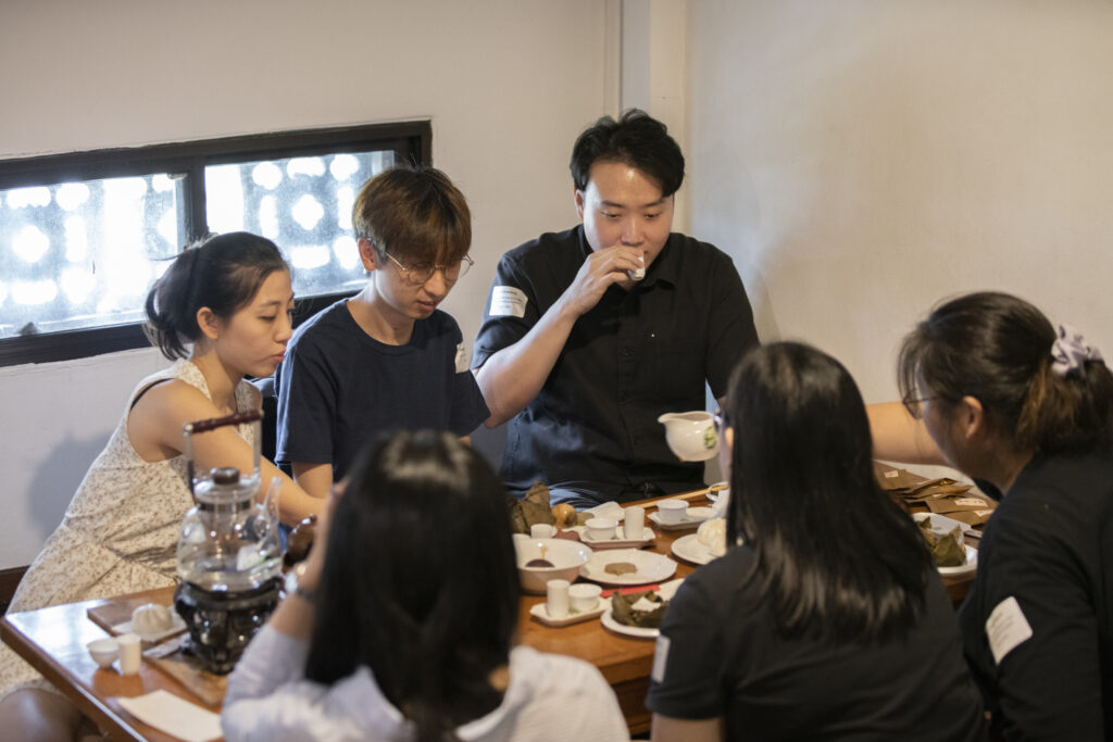 Participants try their hand at brewing some aromatic tea